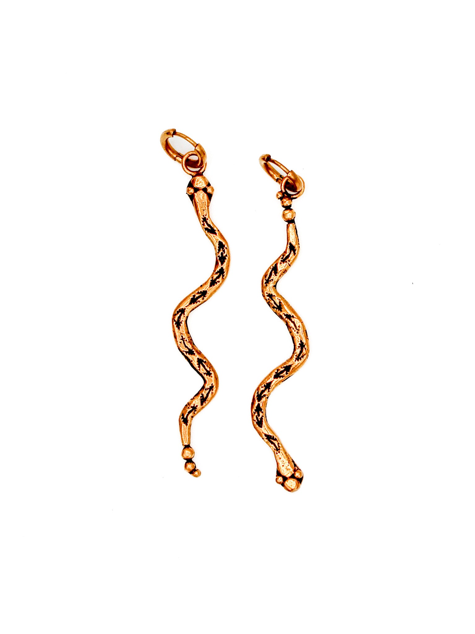 Gold snake-shaped earrings on a white background