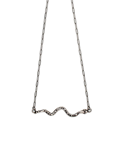 Silver necklace with a snake design on a white background 
