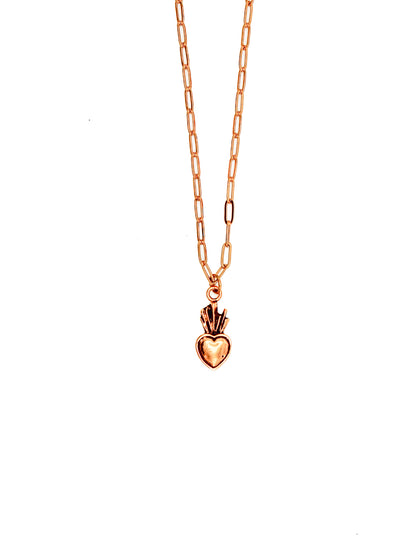 Gold necklace with a heart-shaped pendant on a white background