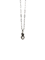 Silver necklace with a heart-shaped pendant on a white background