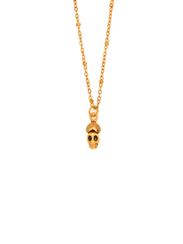 Gold necklace with a skull pendant on a white background