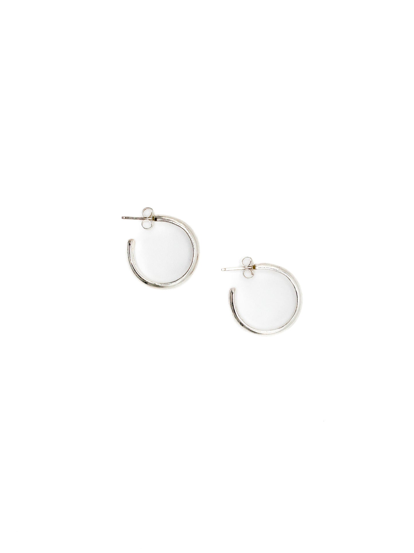 Silver hoop earrings on a white background
